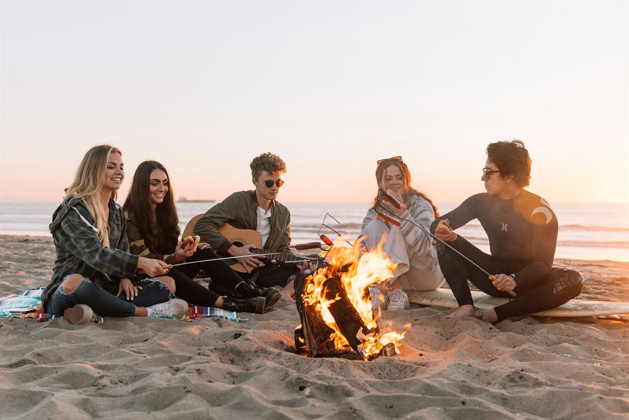 A happy group of friends, young and old, enjoying an outdoor festival.